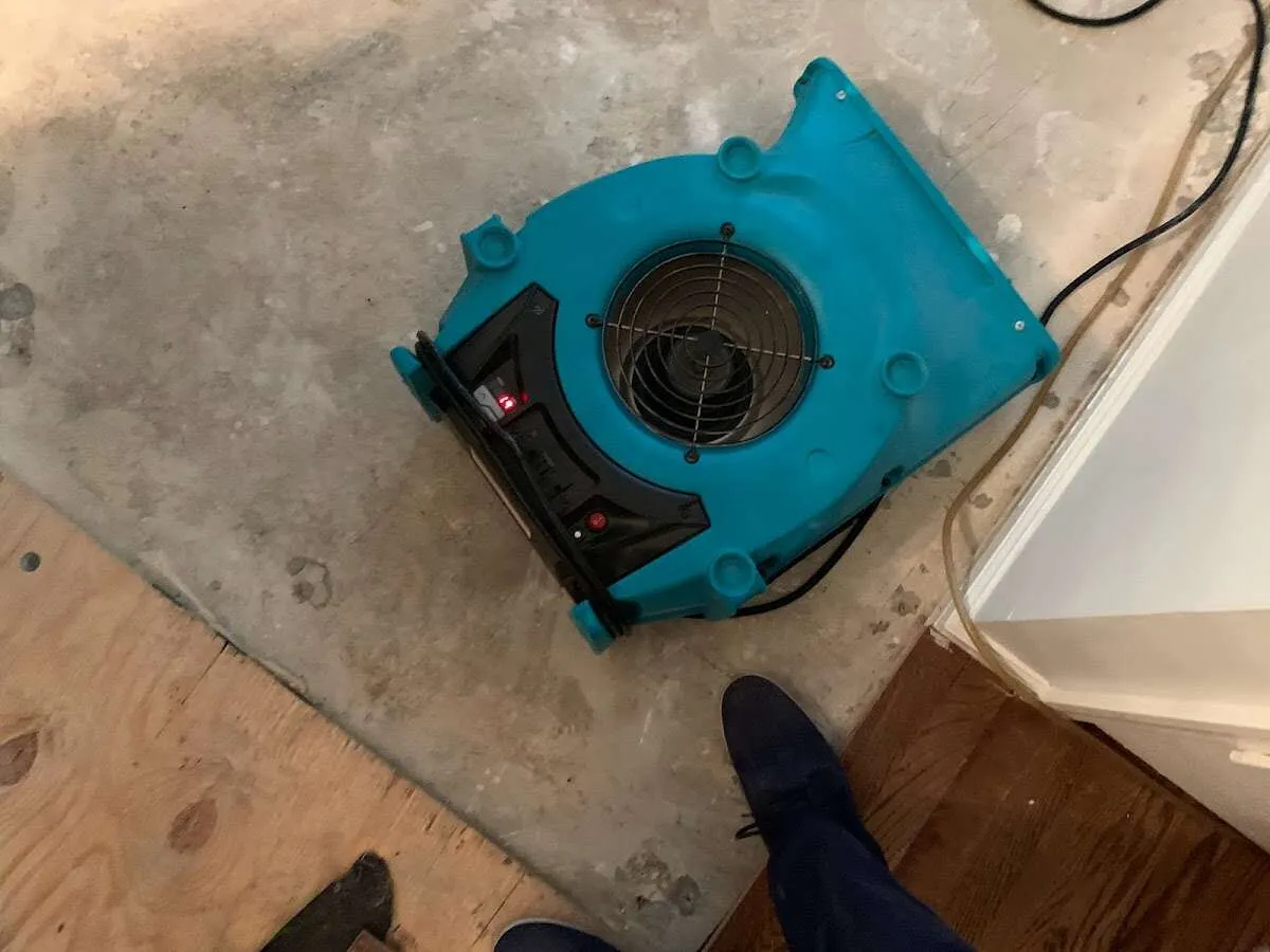 Air mover drying subfloor during Leak Detection & Repair in Villas